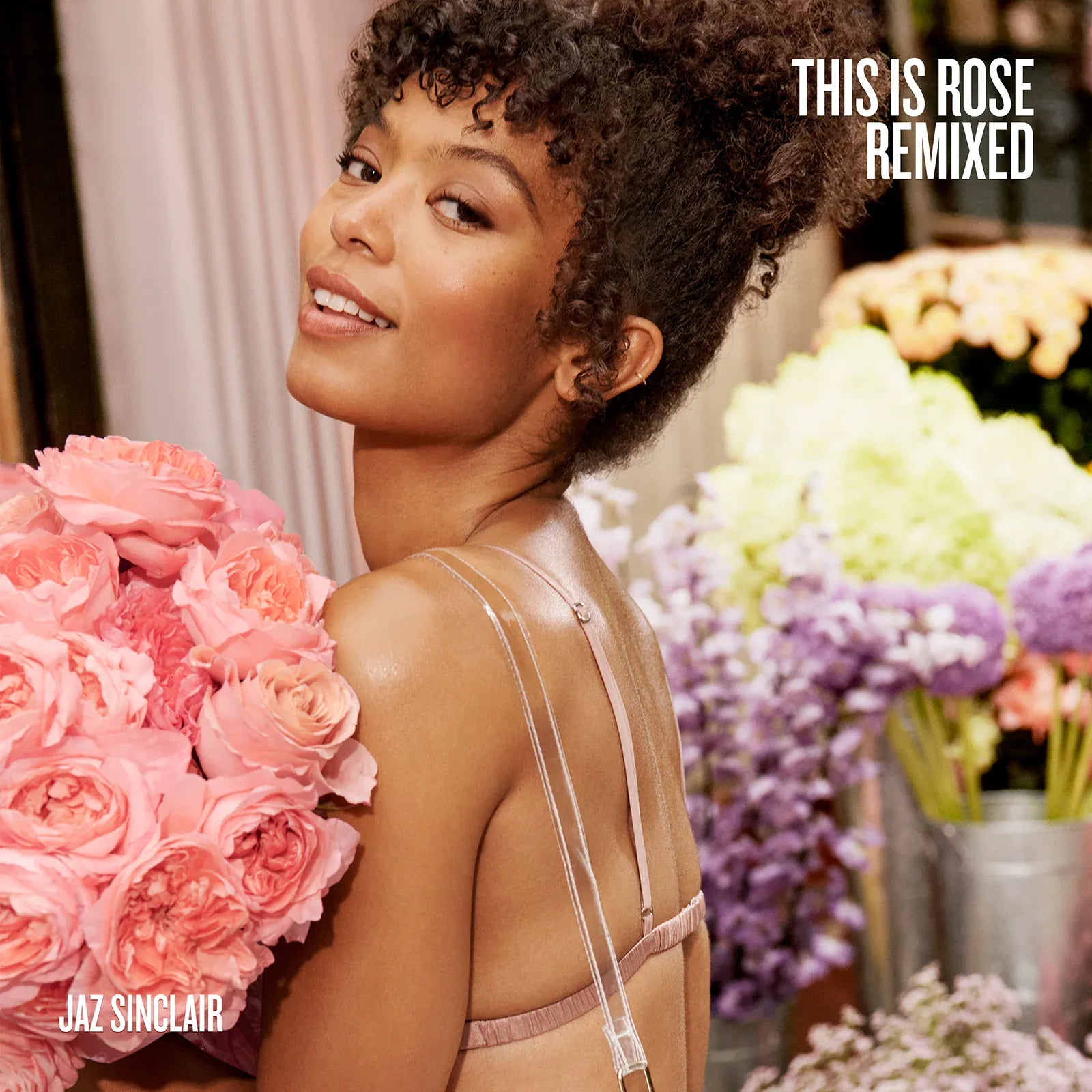 Woman holding pink roses with floral decorations and text 'This is Rose Remixed' and 'Jaz Sinclair'.
