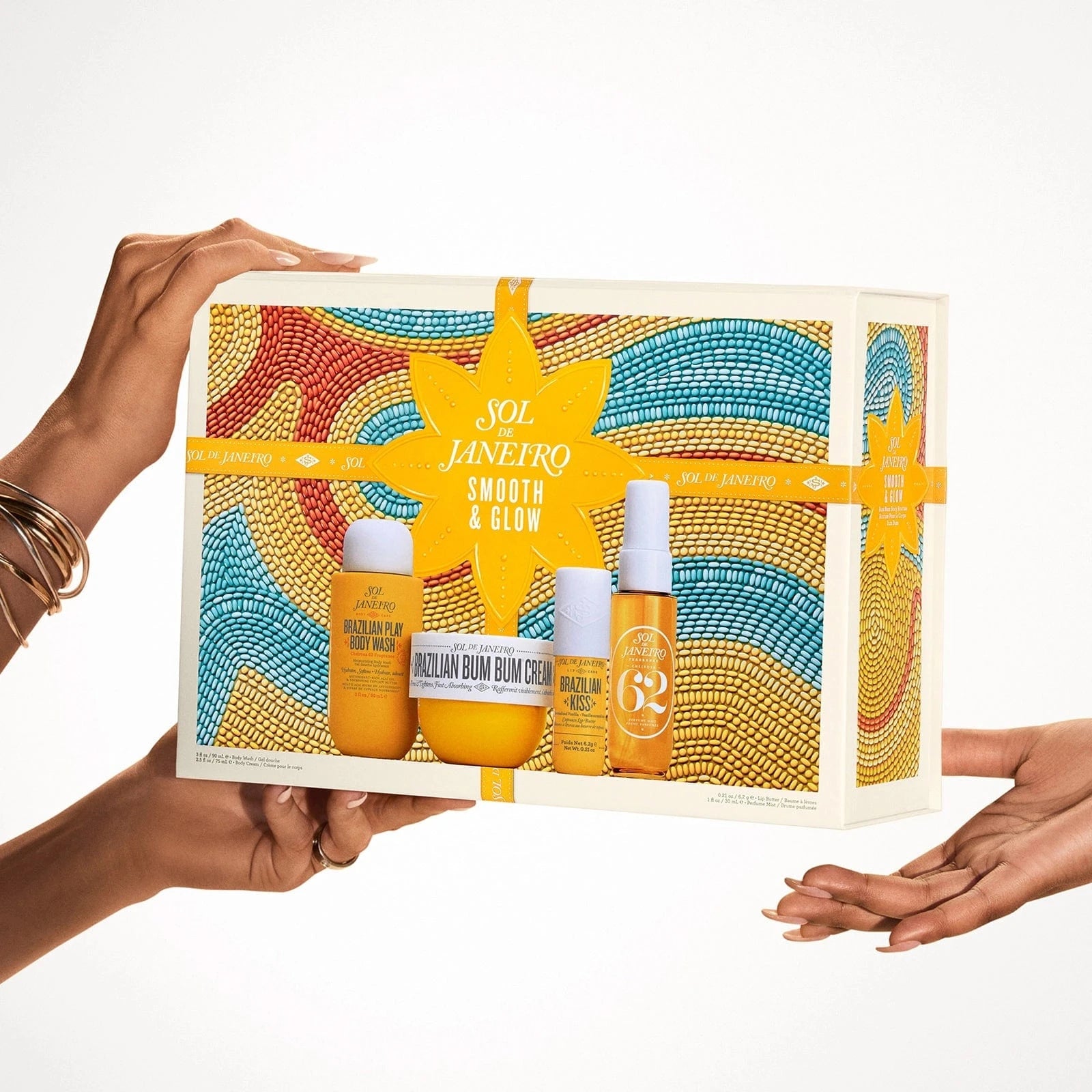 sol de janeiro smooth and glow bum bum body routine box routine set with models hands holding the box